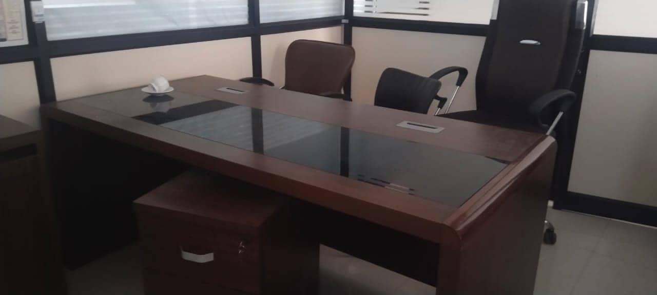 Executive desk with glass top and office chairs