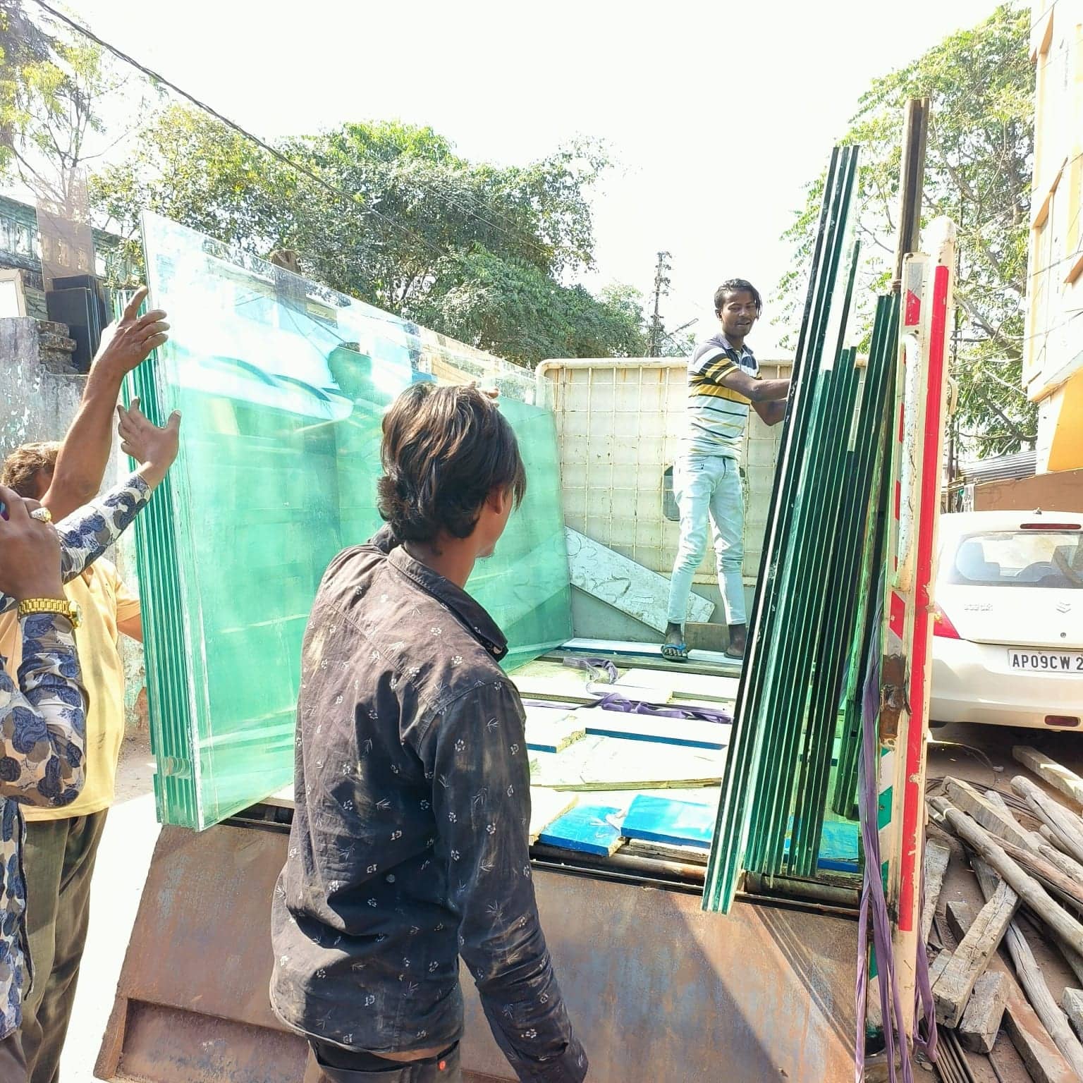 Team loading glass partition panels onto a truck
