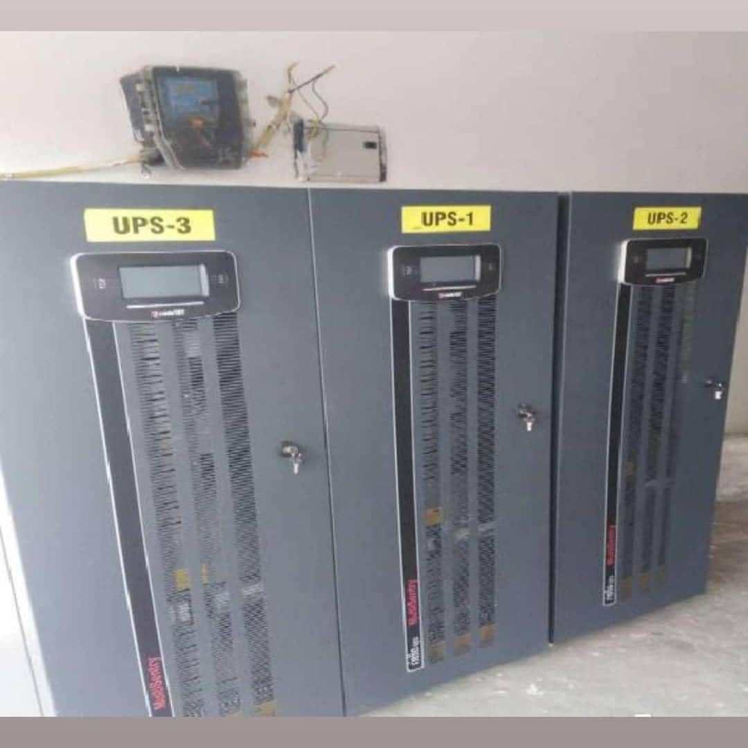Three commercial UPS cabinets in a plant room